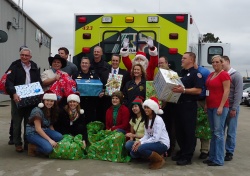 Acadian Ambulance delivers Christmas gifts at Girls' Haven.
